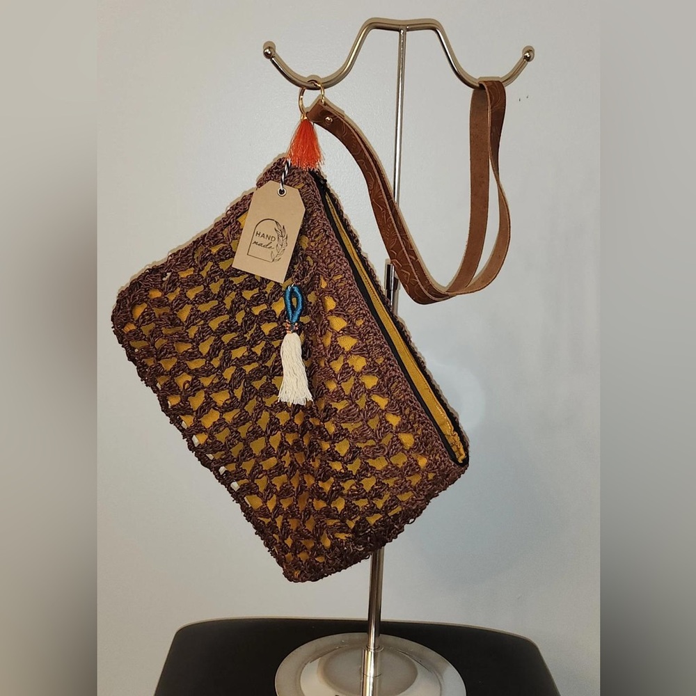 Small brown clutch bag with single strap
